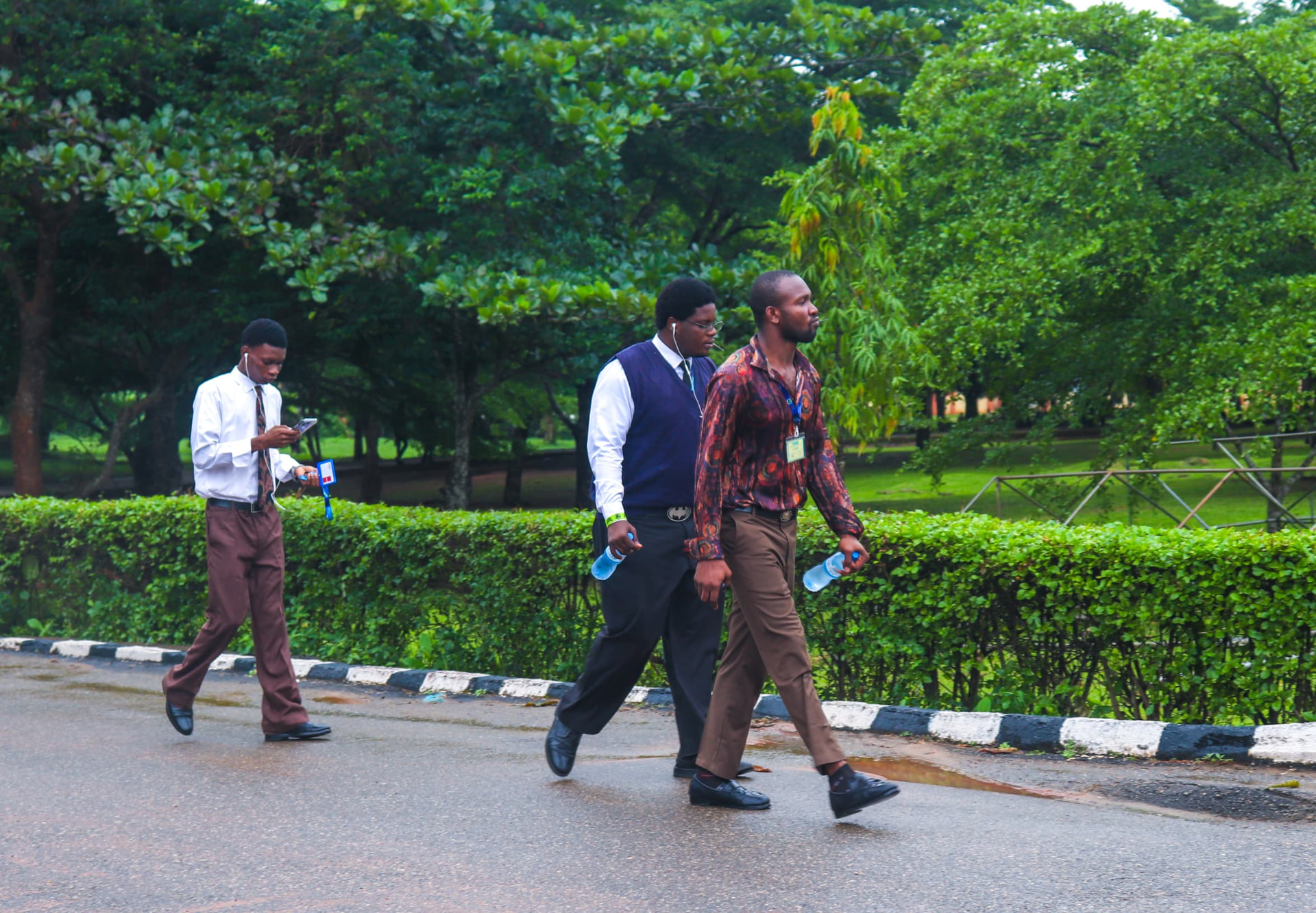 Caleb University students walking along a tree-lined campus road