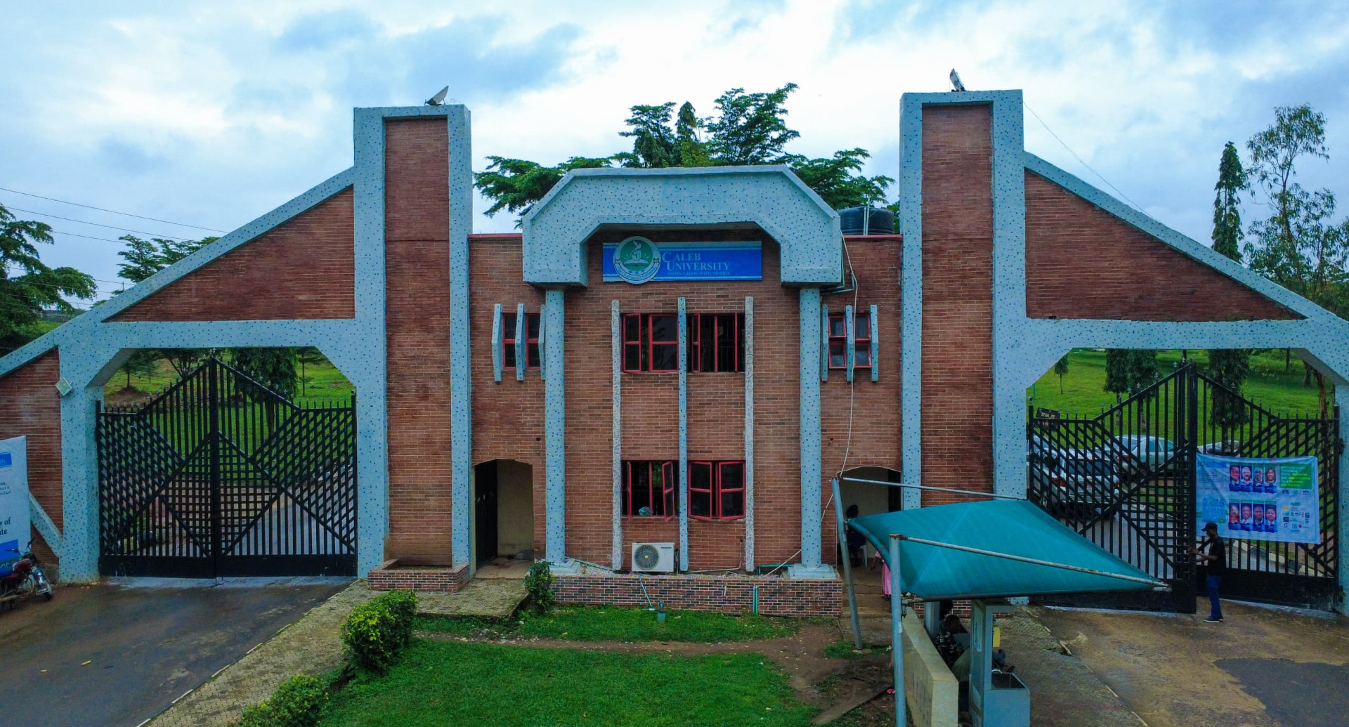 Caleb University main entrance gate with blue signage